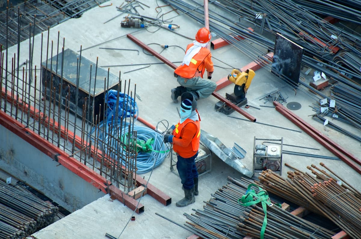 Construction workers on a job site with steel rebar